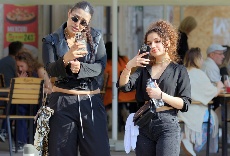 Two young women looking at their smartphones